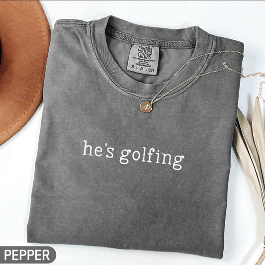 he's golfing - white font